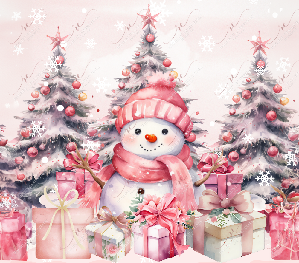 A happy snowman sitting in front of 3 Christmas trees with pink stars and ornaments and pink wrapped presents. The snowman is wearing a pink scarf and toboggan.