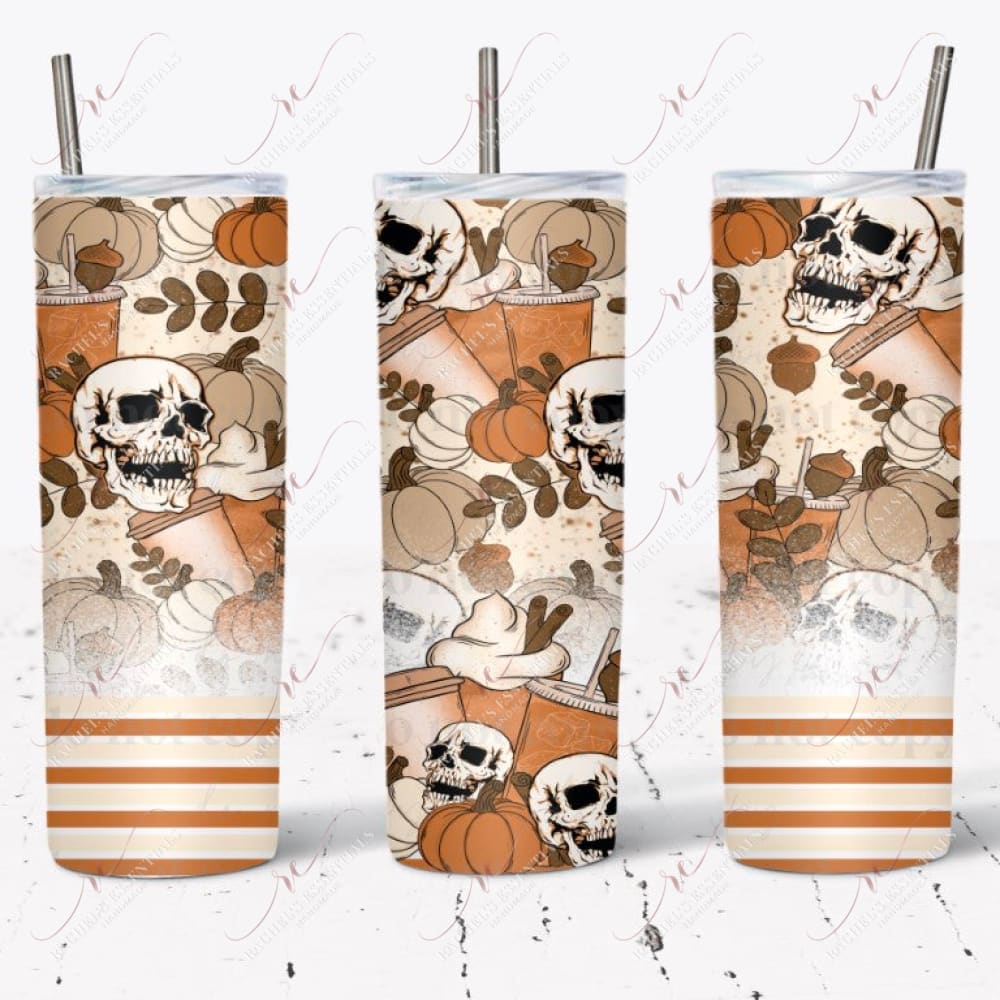 Fall pumpkin spice tumbler design. The bottom of the patter is orange, yellow, and white stripes. A white splatter effect rises slightly above it. The remaining part of the design has brown acorns, cream and orange pumpkins, skulls, and pumpkin spice drinks.