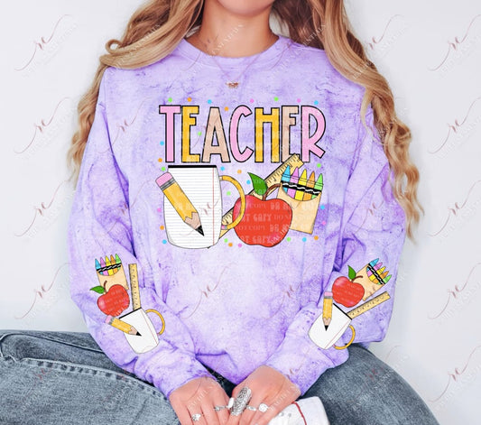 The word teacher in yellow and pink. Below is a pencil, paper mug, ruler, apple and box of crayons. Colored dots are surrounding the design