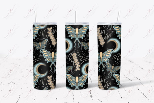 seamless tumbler featuring a black background, blue and brown crescent moon with small black dots and brown and blue moth rising up