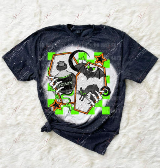Bleached dark heather grey shirt featuring a halloween design. The design is 2 orange coffins with skeleton hands coming out of the side holding a bottle of poison and a black cat. A black bat, spider web and crescent moon are also featured throughout the design. Neon green checkered squares are in the background of the design.