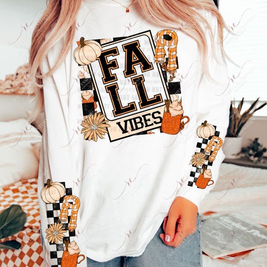 Model wearing a white long sleeve shirt with a fall design on the front and the sleeves. The front image is a polaroid picture that says fall vibes. Pumpkin spiced lattes, pumpkins, scarves and flowers are surrounding the image. The sleeves are black checkered background with a cream pumpkin, orange and cream scarf, yellow flower and a pumpkin spice latte.
