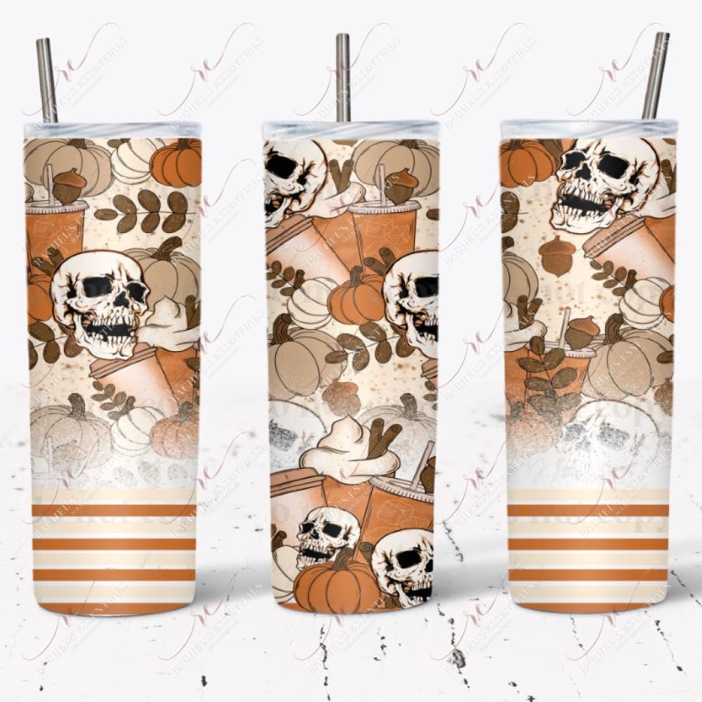 Fall pumpkin spice tumbler design. The bottom of the patter is orange, yellow, and white stripes. A white splatter effect rises slightly above it. The remaining part of the design has brown acorns, cream and orange pumpkins, skulls, and pumpkin spice drinks.  