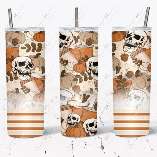 Fall pumpkin spice tumbler design. The bottom of the patter is orange, yellow, and white stripes. A white splatter effect rises slightly above it. The remaining part of the design has brown acorns, cream and orange pumpkins, skulls, and pumpkin spice drinks.  